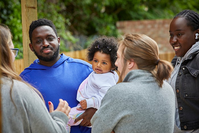 SNG residents talking to SNG employees in a community garden