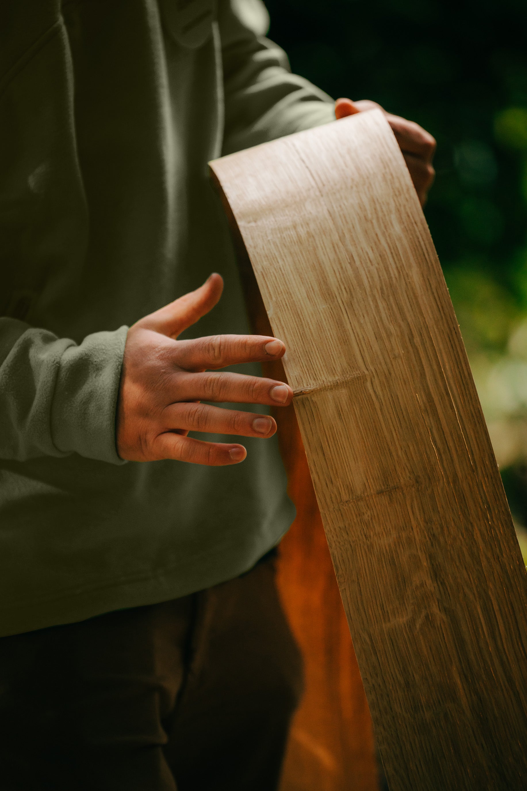 A person holding wood veneer