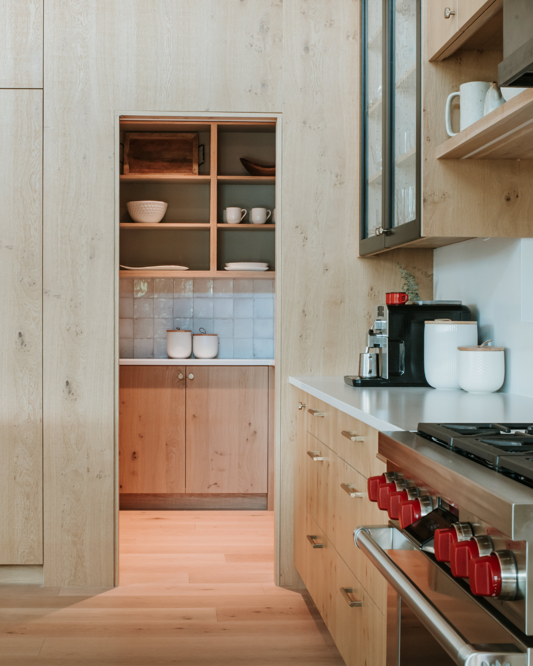 A kitchen with a wood wall and cabinets - wood veneer - natural oak