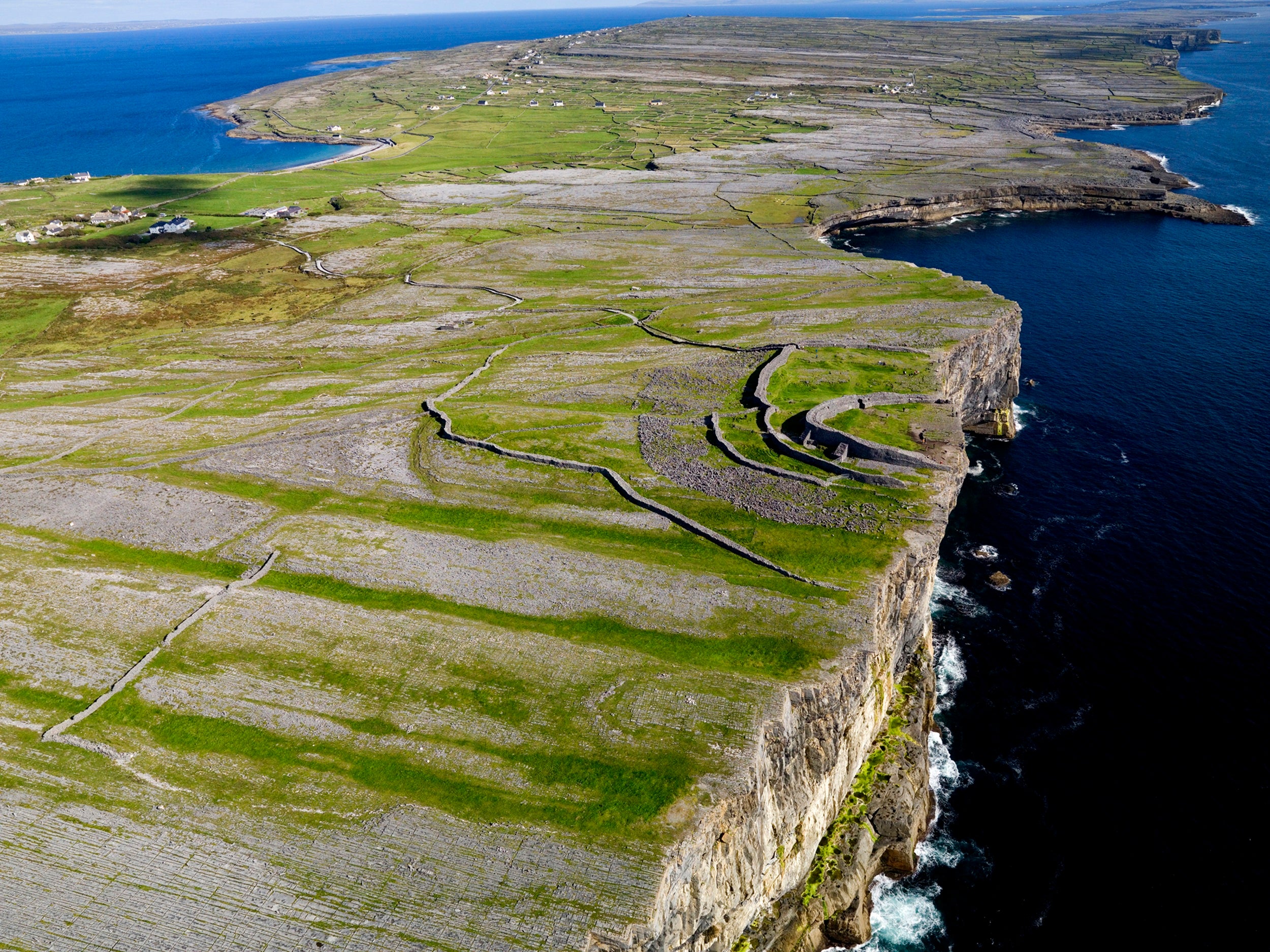An aerial view of a large land with a body of water
