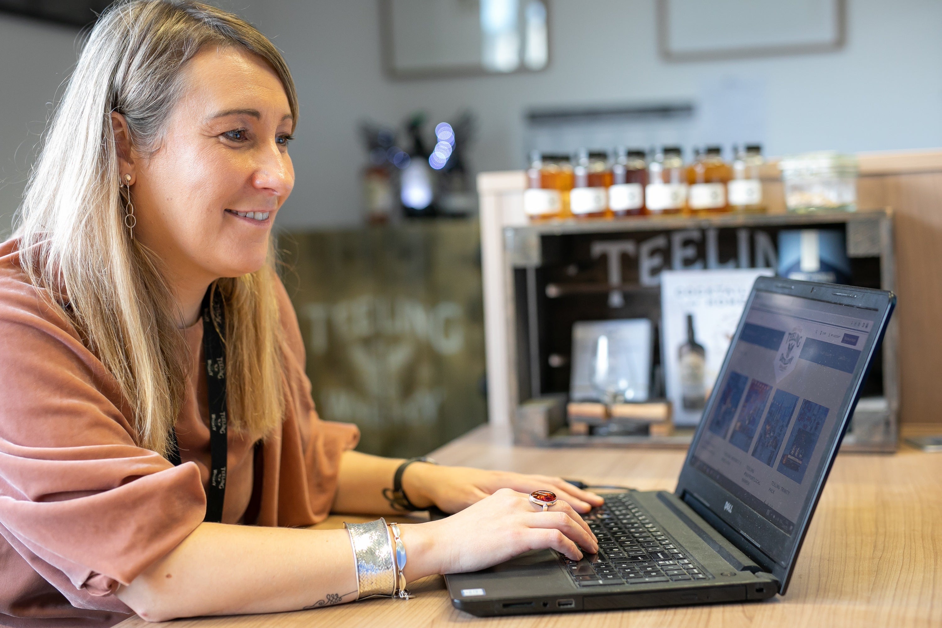 A woman sitting at a table using a laptop
