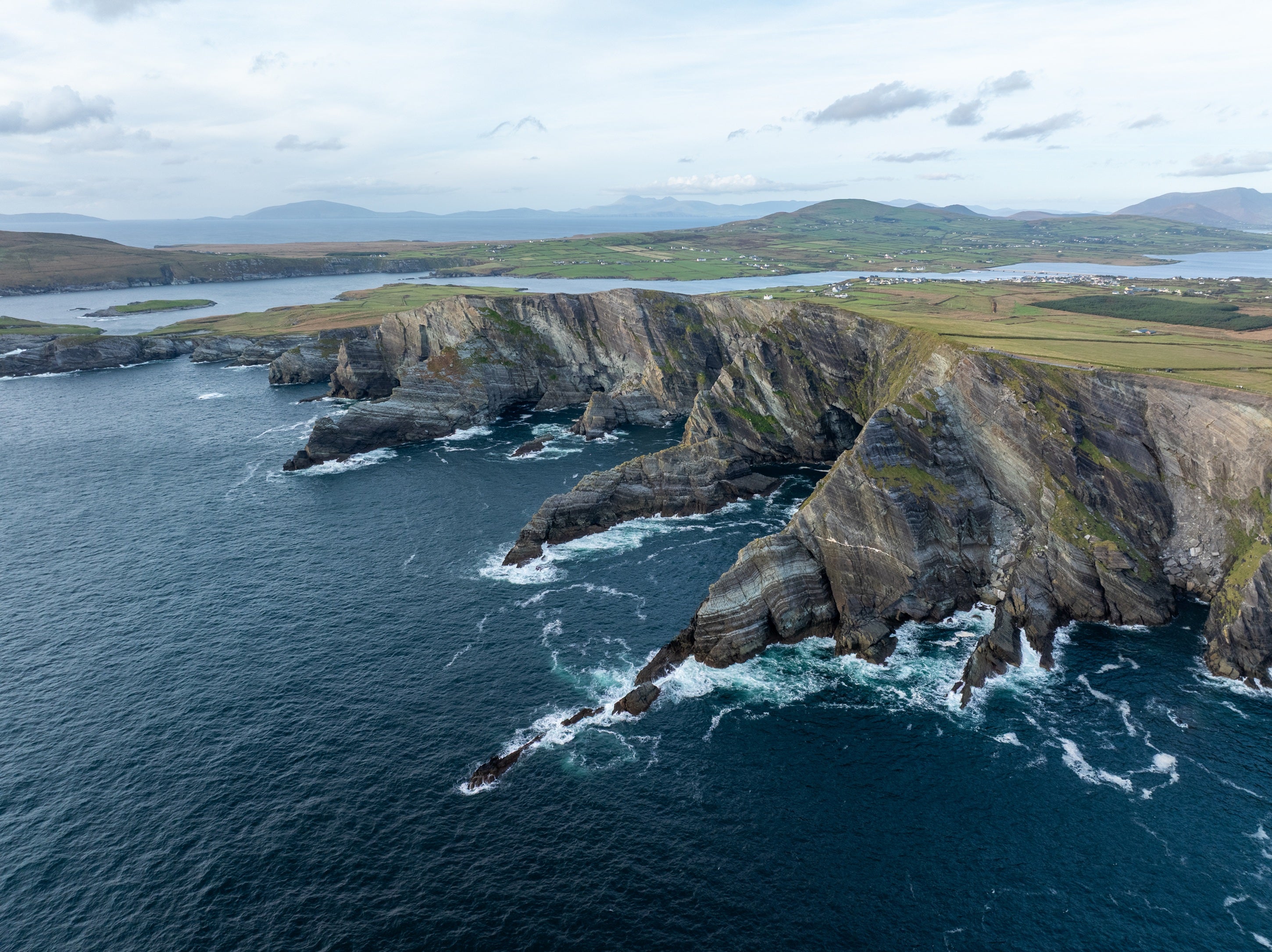 A large rocky cliff above water