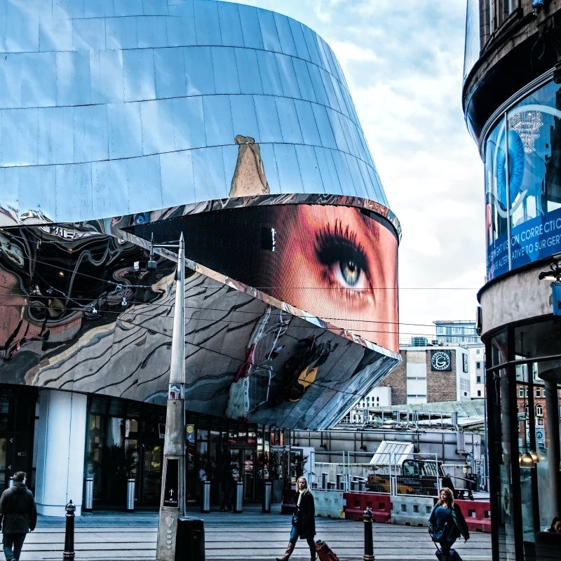 Woman walking past a mural