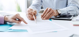 Osoba ukazujúca na papier