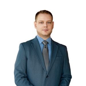 Mężczyzna w garniturze i krawacie Jacek Stolarczuk