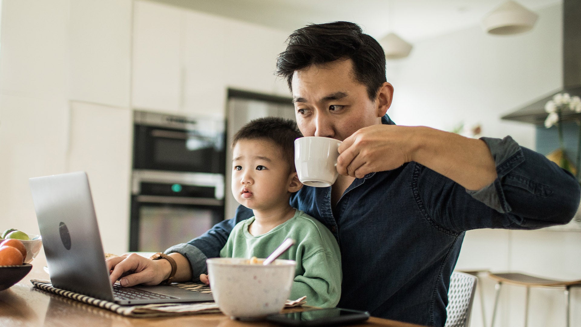 Man and child using laptop