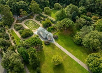 Aerial view of a well maintained garden and glasshouse