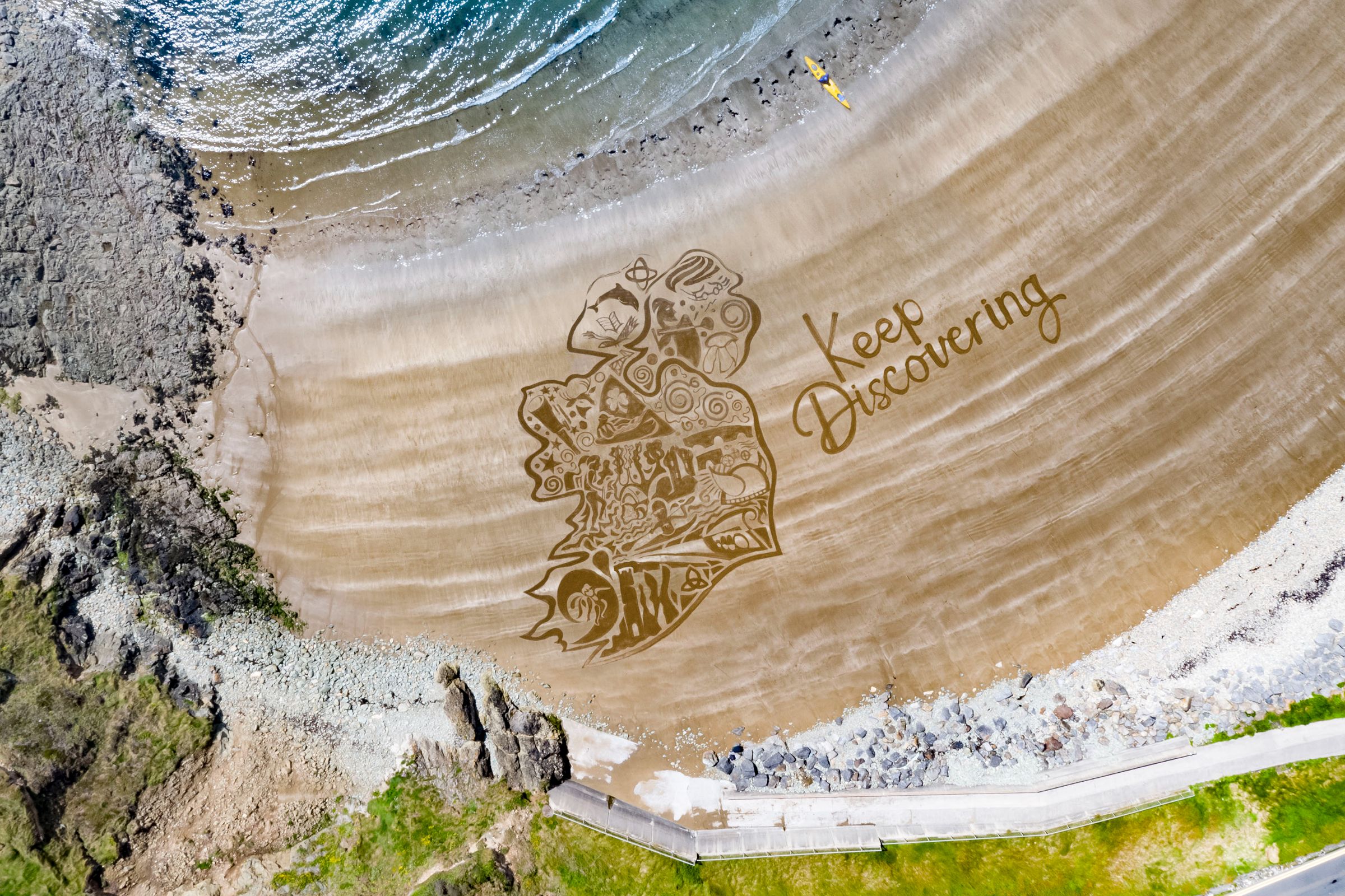 The Keep Discovering logo overlaid on golden sand at Kilmurrin Beach, County Waterford