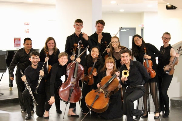 Muicians smiling with their instruments