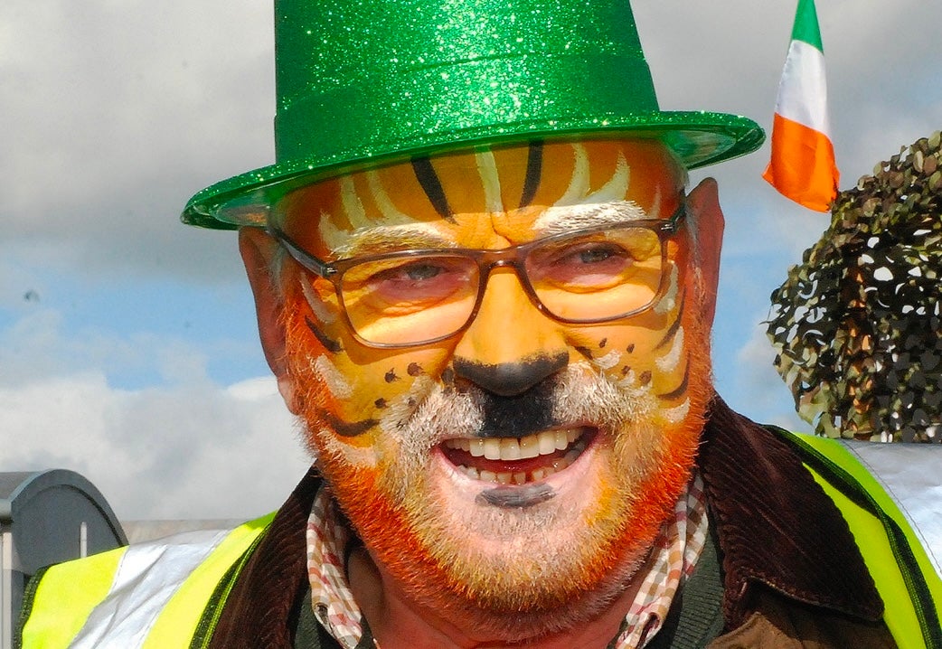 Roscrea Goes Green - St Patrick’s Day Parade, a man with painted orange cat face and sparkly green hat.