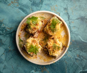 Food on a white plate with a blue backdrop