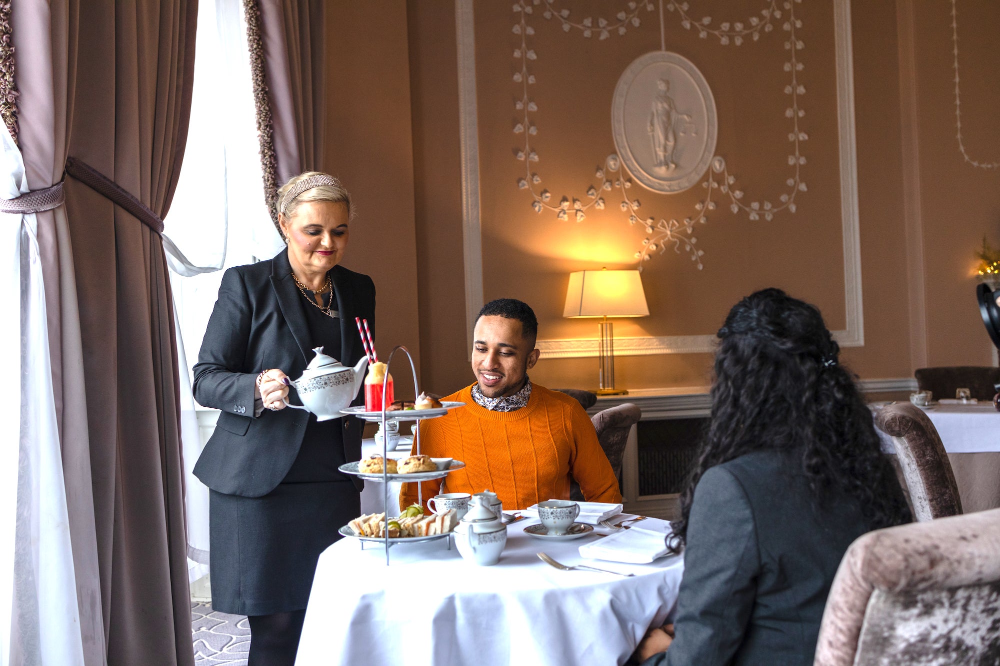 A couple being served afternoon tea at Mount Juliet Estate in County Kilkenny