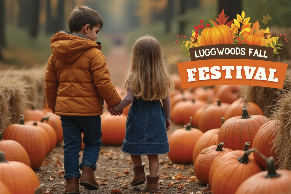 2 small children walking down a path lined with large pumpkins and bales of hay.