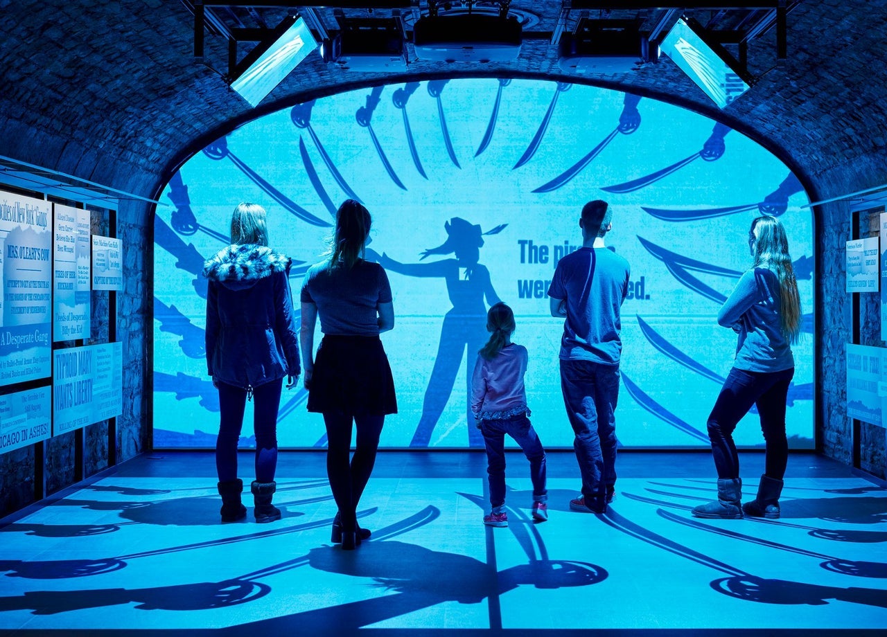 A group of people watching a visual display