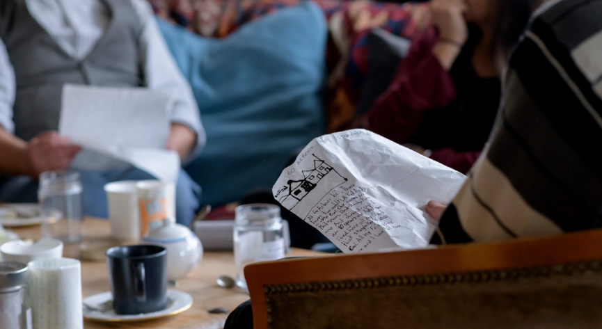 Image credit Louis Haugh. A person reading a written story as part of an art project.