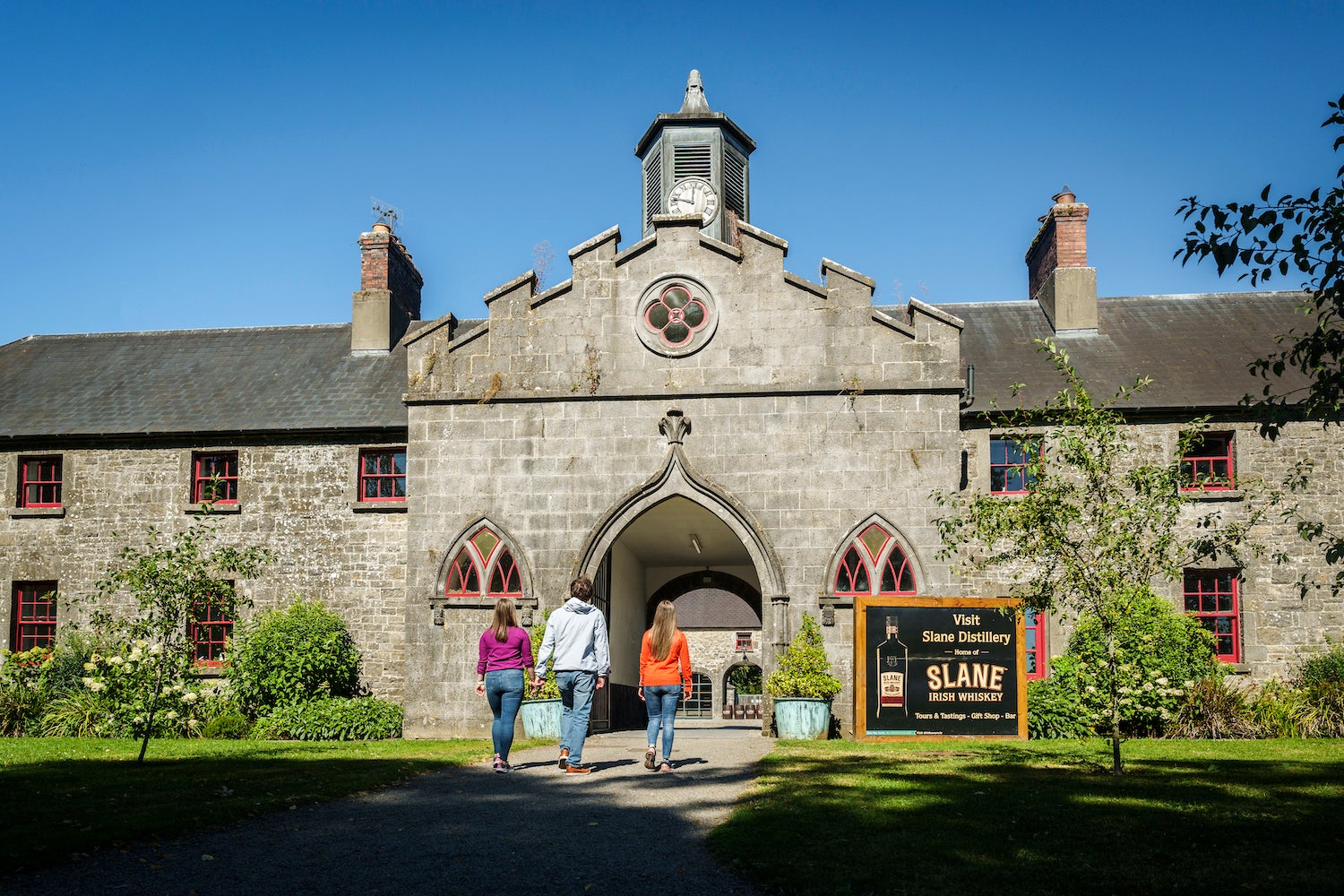 Three people walking into the Slane Distillery in County Meath