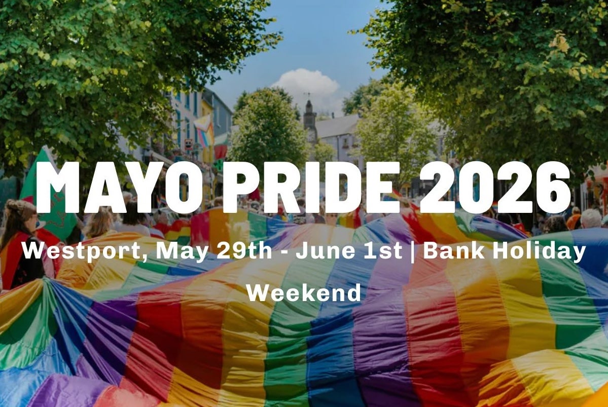 A large rainbow coloured flag is being carried flat along a busy street by lots of people overlaid with white event text info.