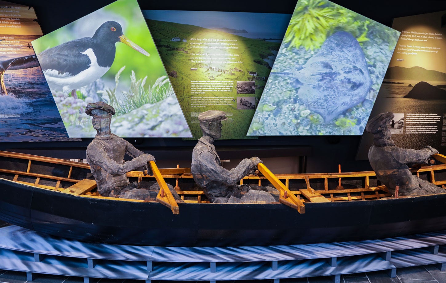 A model of curragh boat with three men rowing on display at the The Blasket Centre