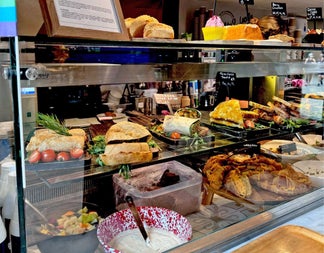 Glass shelving in a tea room with food decoratively displayed
