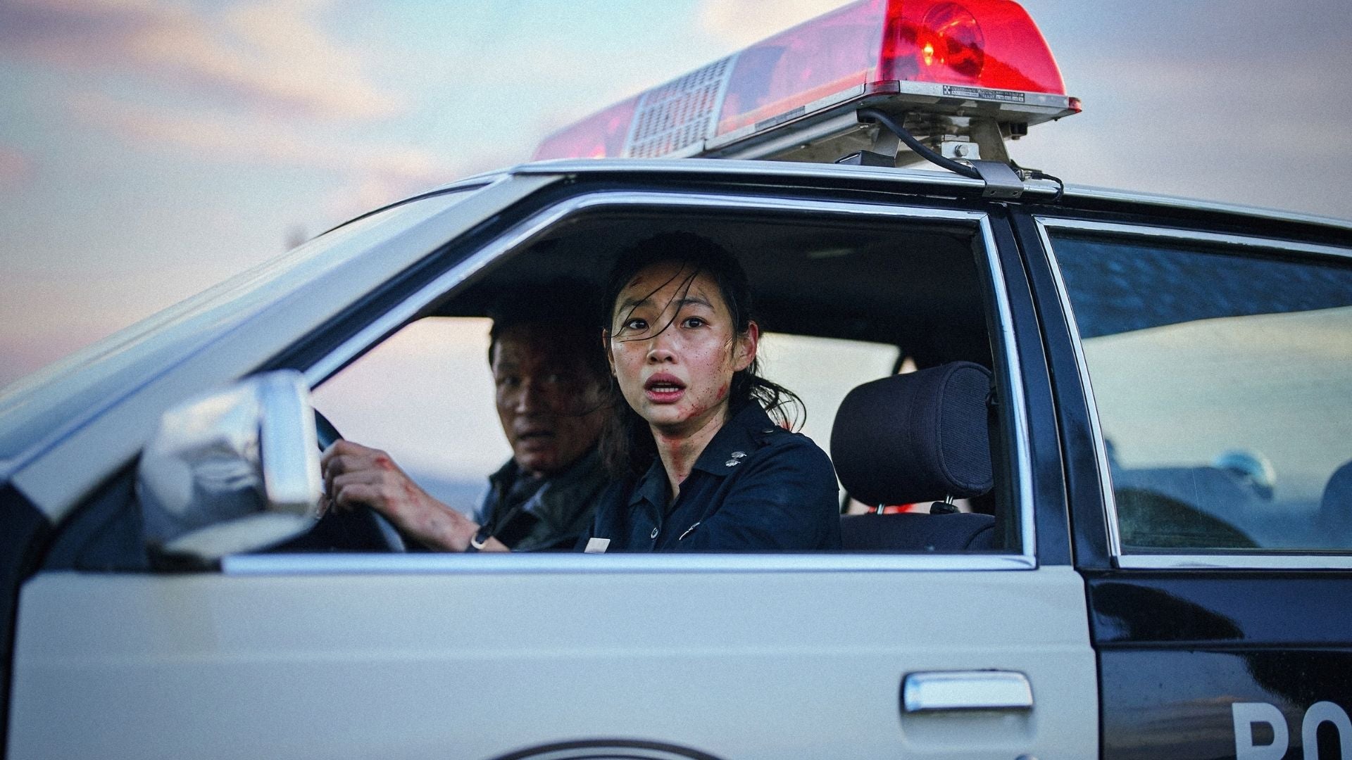 Two scared police officers in a police car.