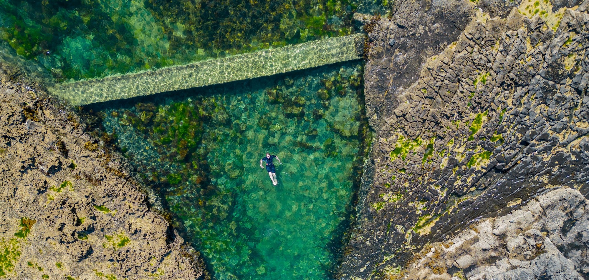 Someone swimming in Poll Gorm Natural Swimming Pool in Easkey, Co Sligo