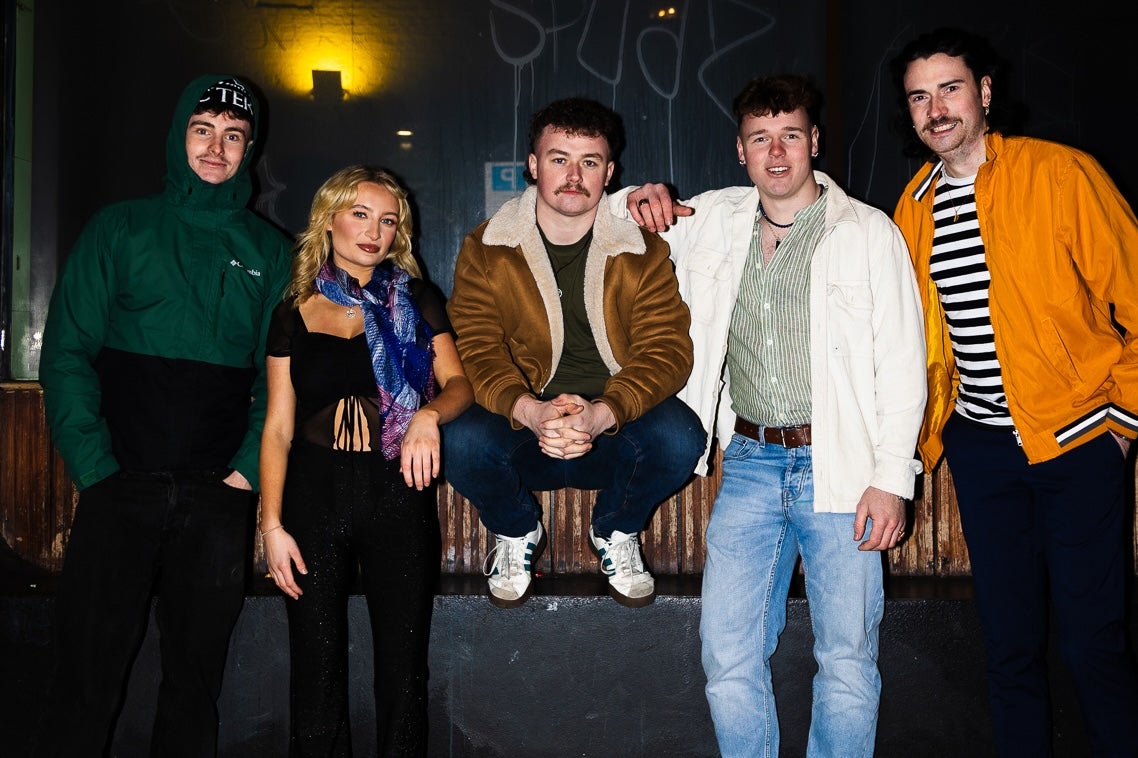 CLADA Live at Belvedere, a group of 4 men and a woman at night.