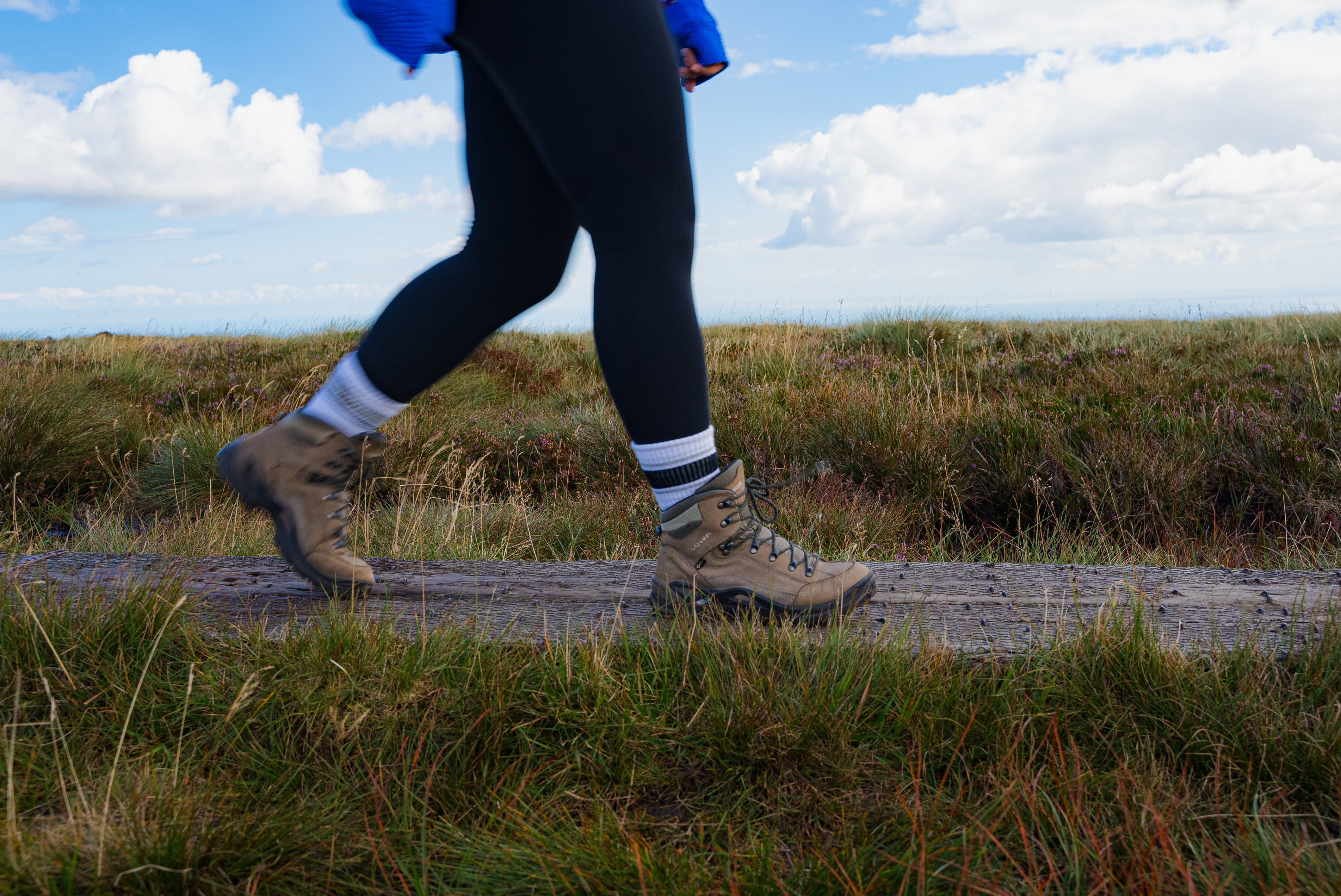 Close up of women's legs walking in hiking boots.