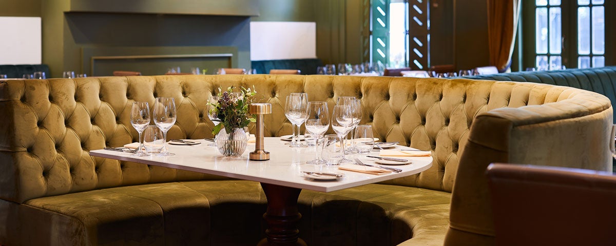 A round seating area with a table laid out for customers