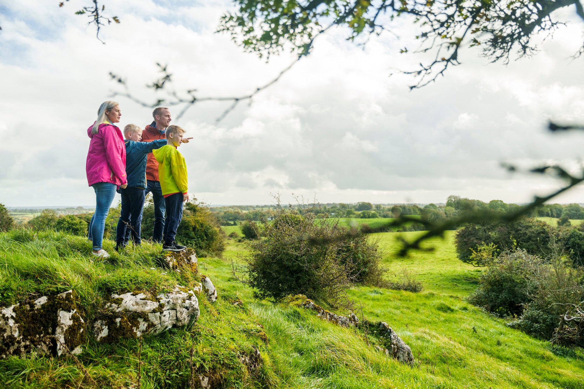 A family of four looking out from Hill of Uisneach in County Westmeath.