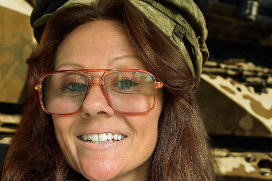 Close up view of person wearing a large pair of glasses and a cloth cap