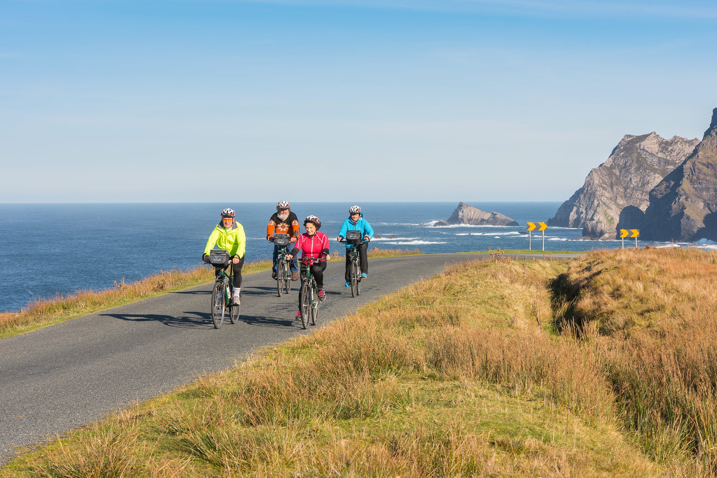 Family cycling along the coast in Donegal