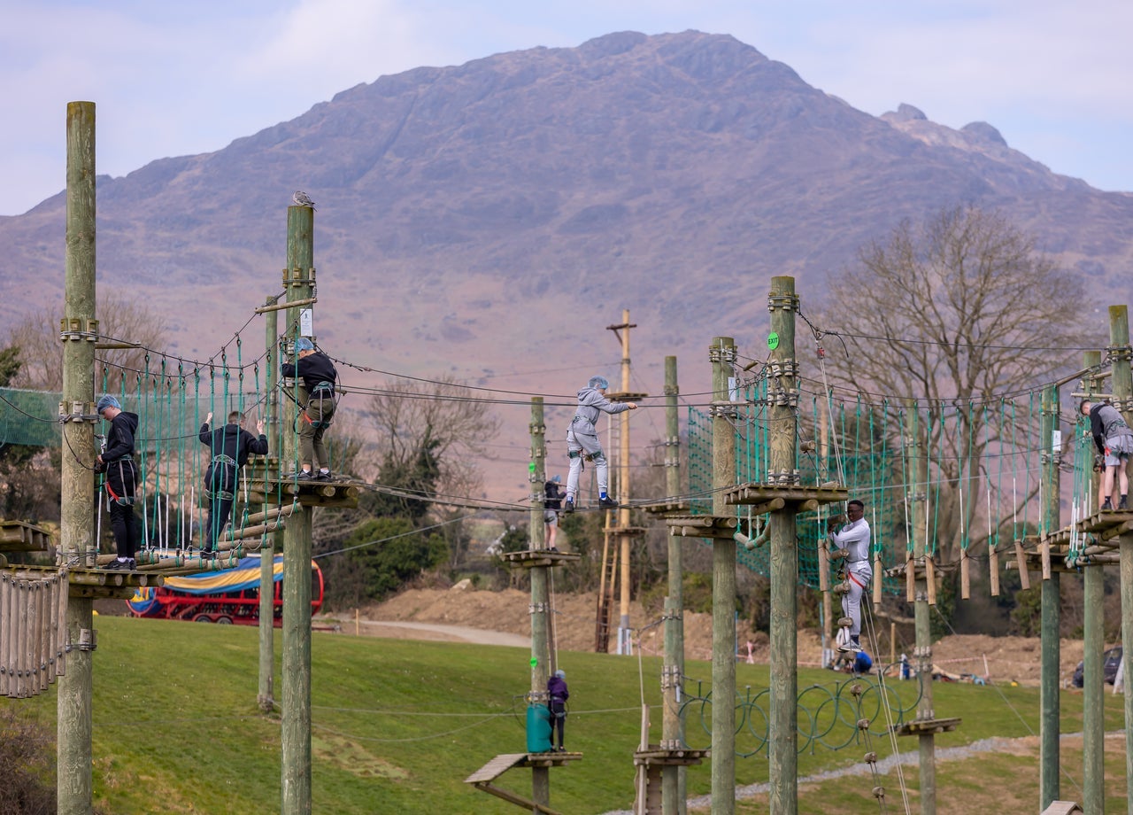 Children walking along suspended rope bridges