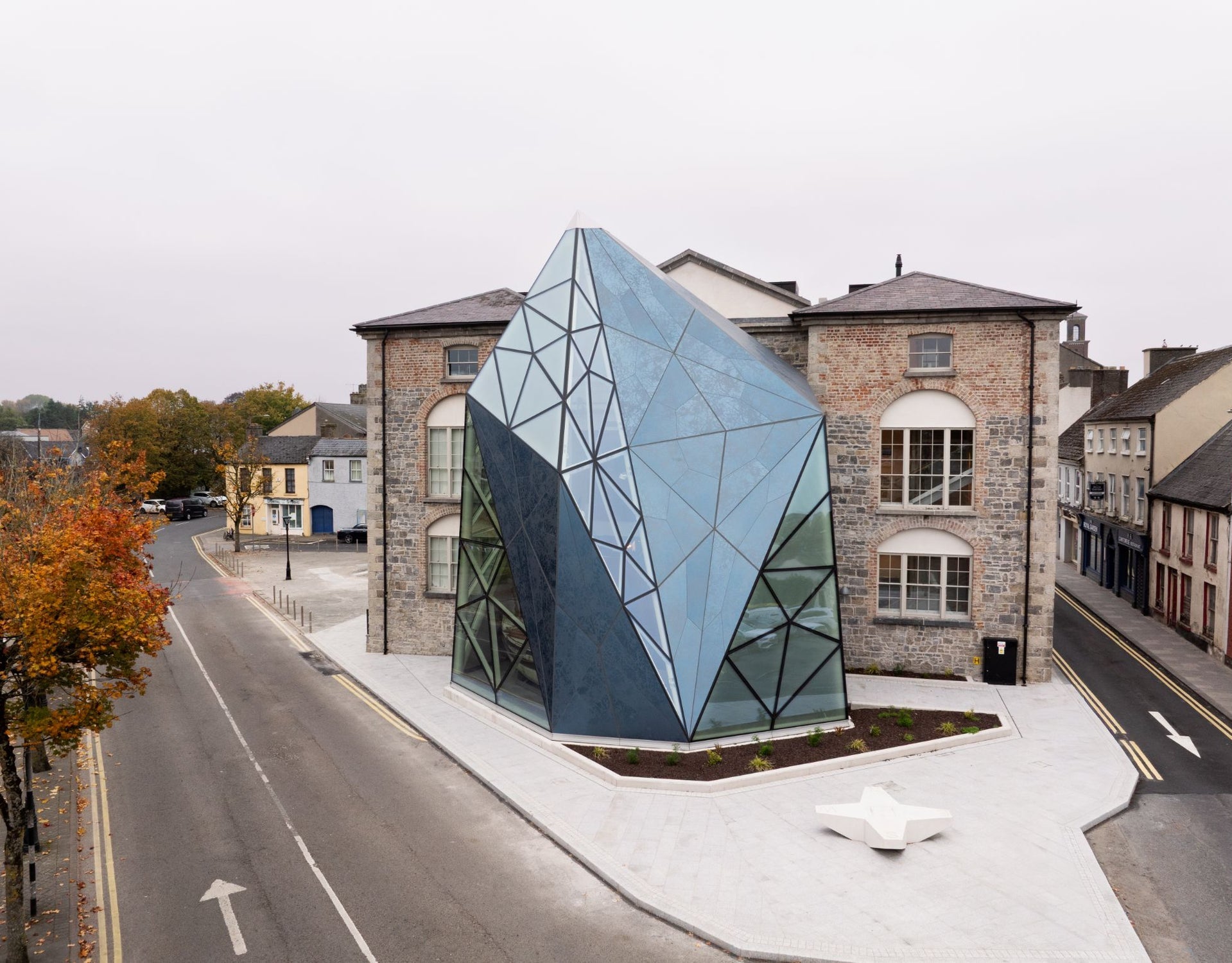 Exterior view of a historic building with a large glass structure attached