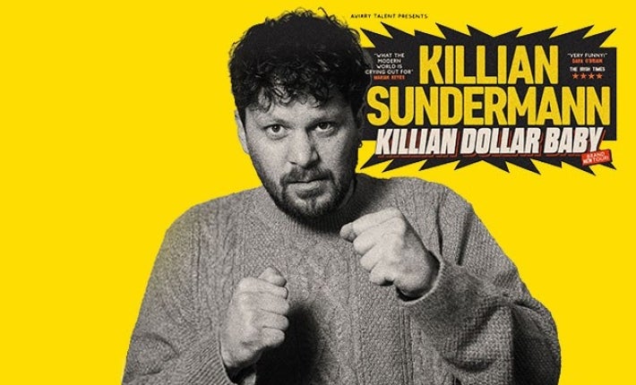 Killian Sunderland, Killian Dollar Baby - a man in knitted jumper holding his hands up in 2 fists.