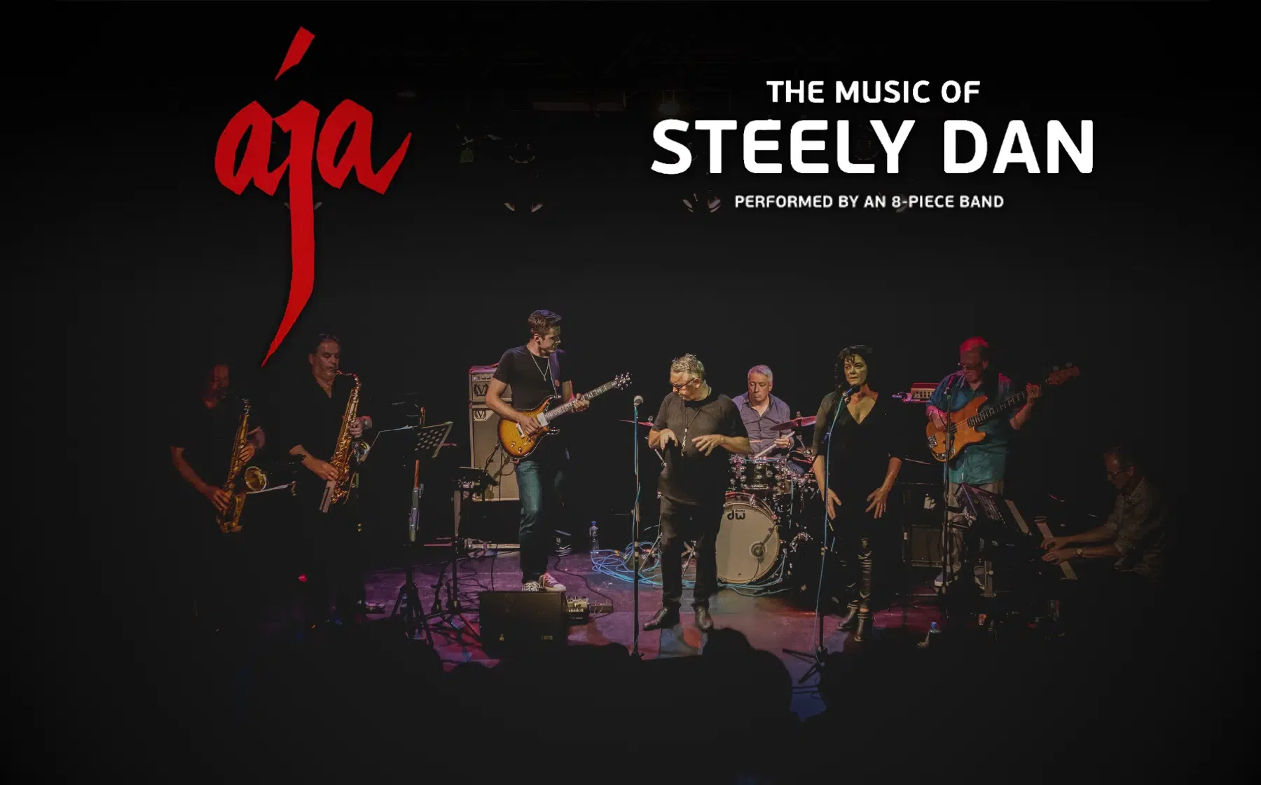 A group of 8 musicians on a small stage