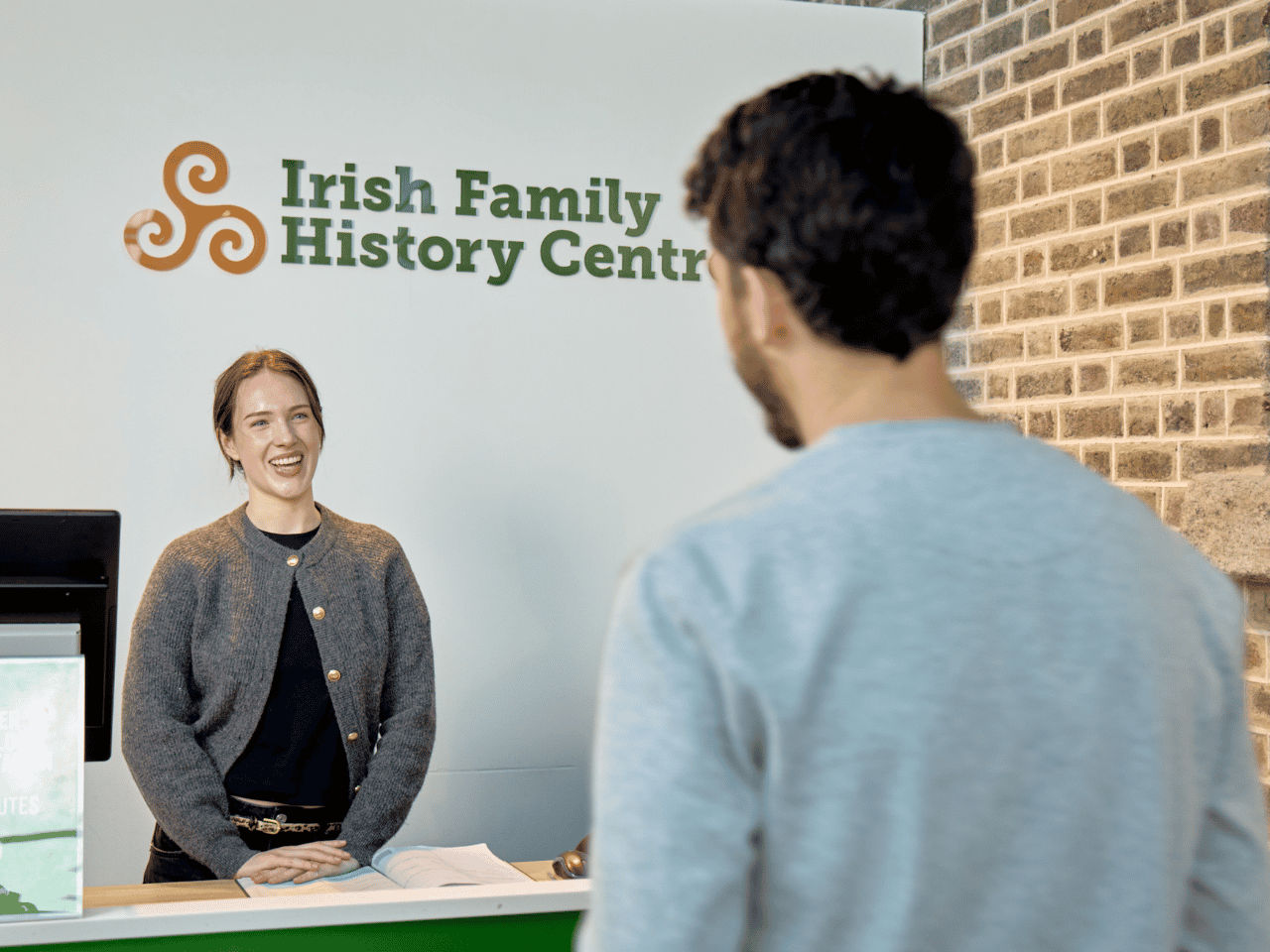 A visitor arrives for a genealogy consultation at the Irish Family History Centre, located at EPIC The Irish Emigration Museum in Dublin's Docklands. Expert guidance helps visitors explore their Irish ancestry.