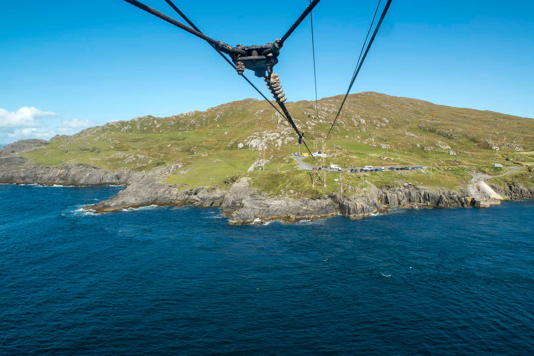 Cables above the sea with mainland in the background