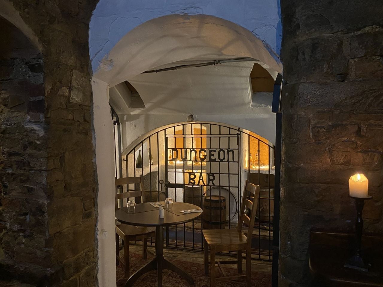 Dimly lit bar with a gated entrance