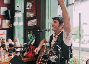 Irish musician singing and playing the guitar at The Irish Dance Party