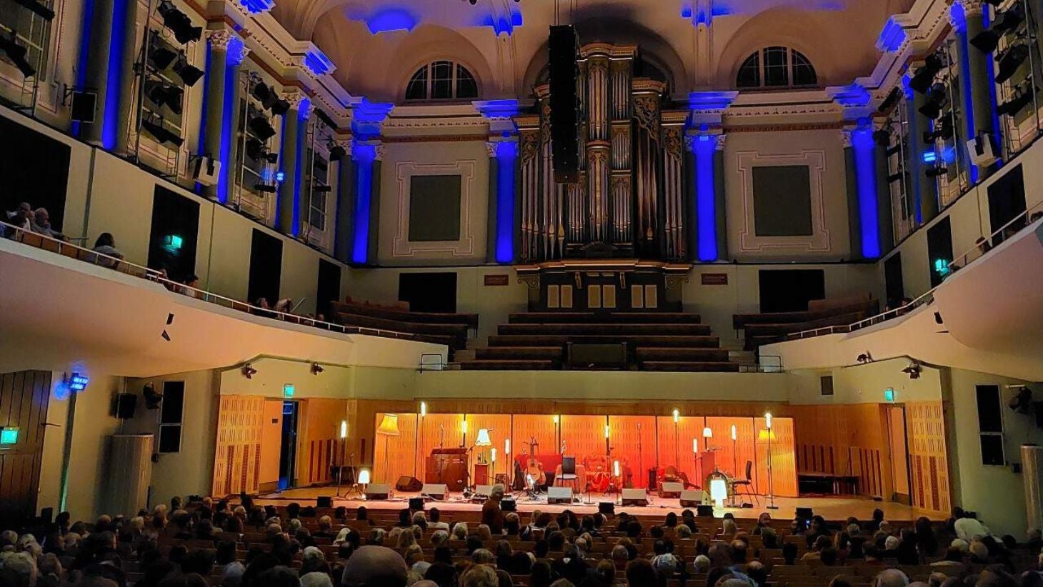 Inside the National Concert Hall in Dublin with rows of people and the stage set up for an orchestra.