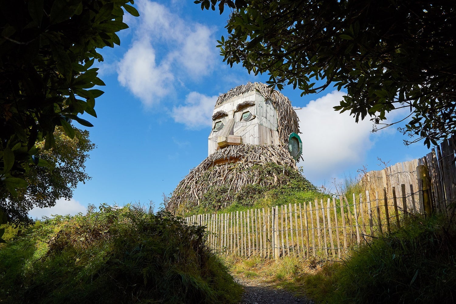 Wooden sculpture of giant man with a beard in a park