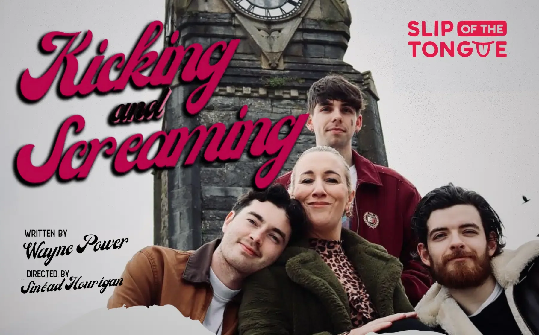 A group of 4 smiling people with a grey clock tower in the background.