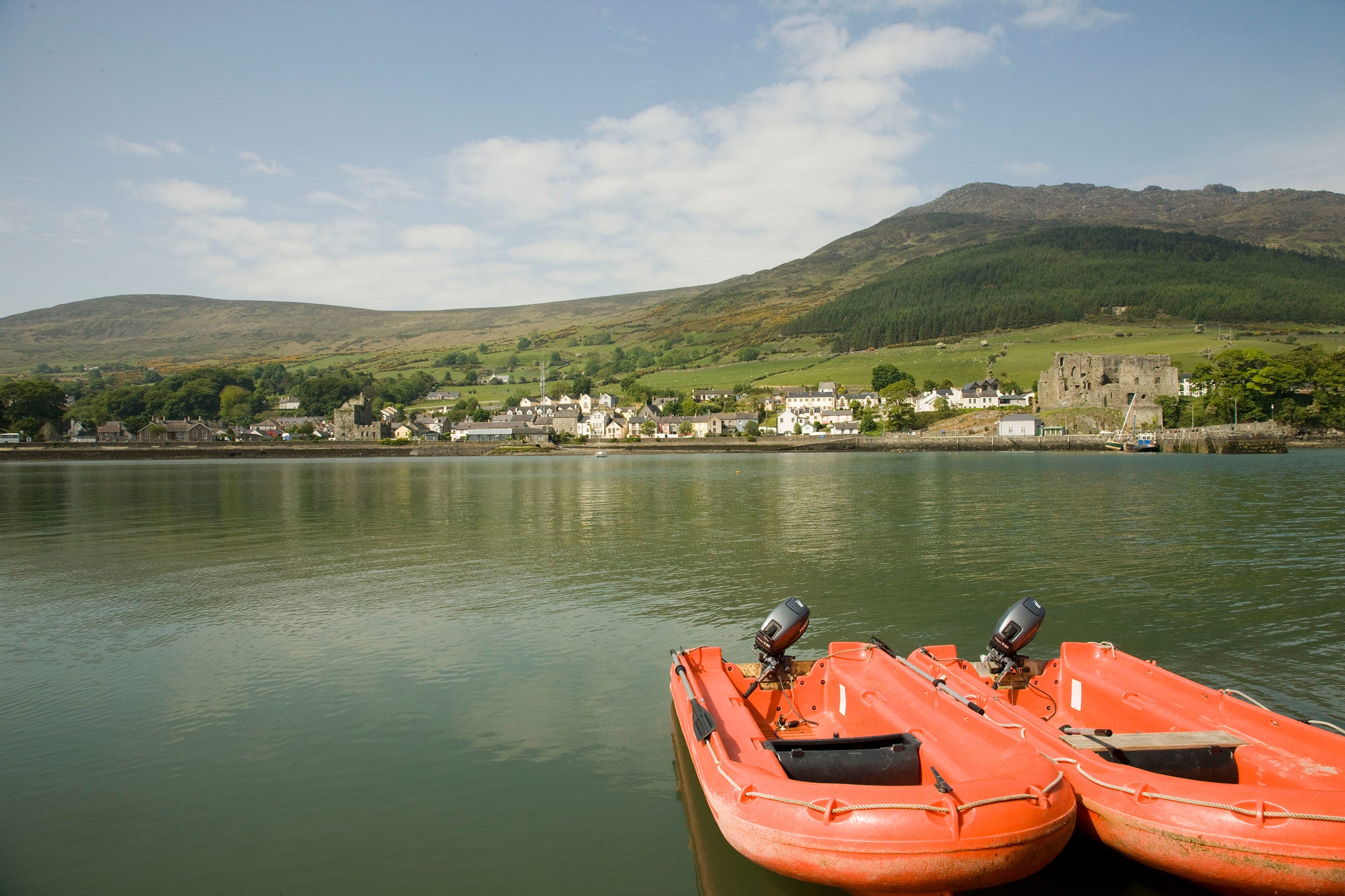 Two orange boats on the water on Carlingford Lough in Louth