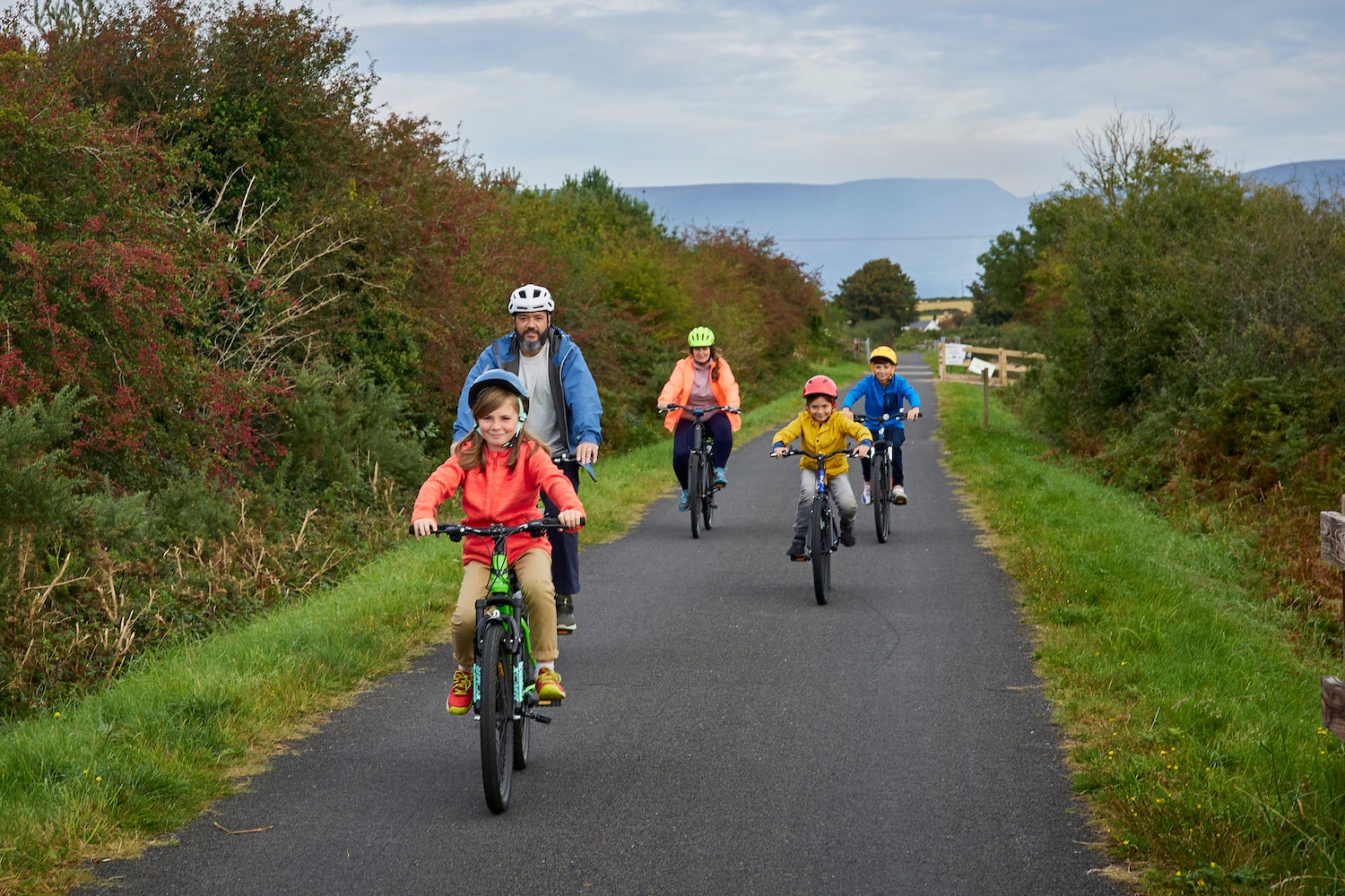 A family cycling the Waterford Greenway