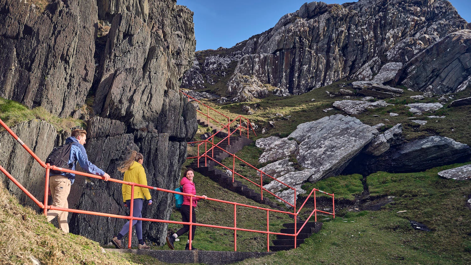 Three people hiking the Sheep's Head Way walking route in County Cork.