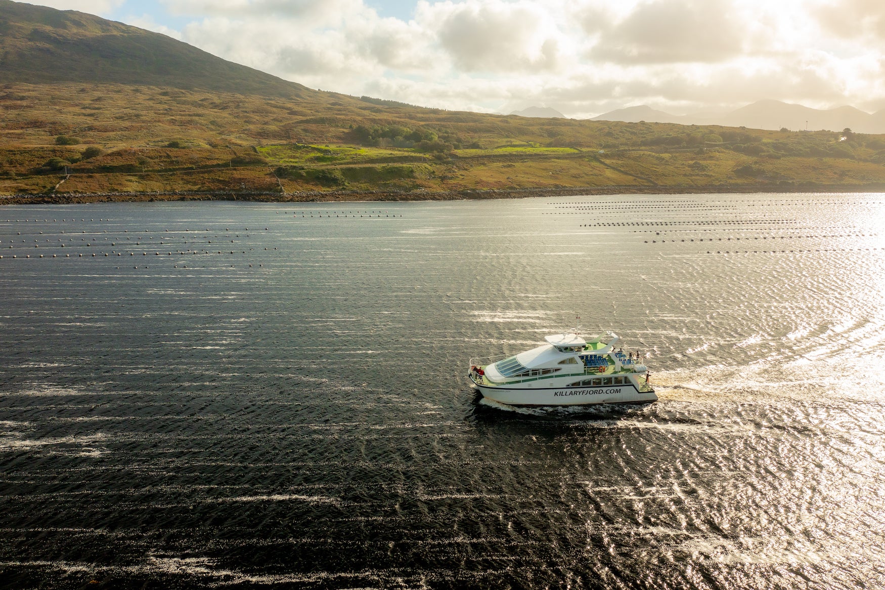 Aerial view of a boat cruising in Killary Fjord in Co Galway