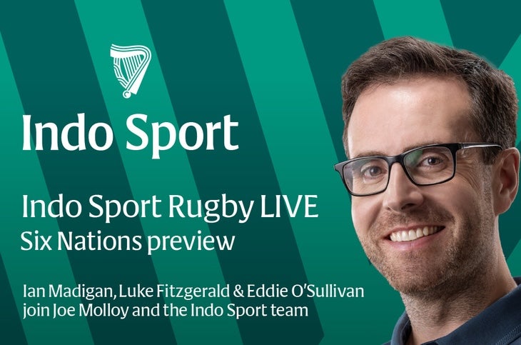 A smiling man in blue shirt with background of green stripes and white text