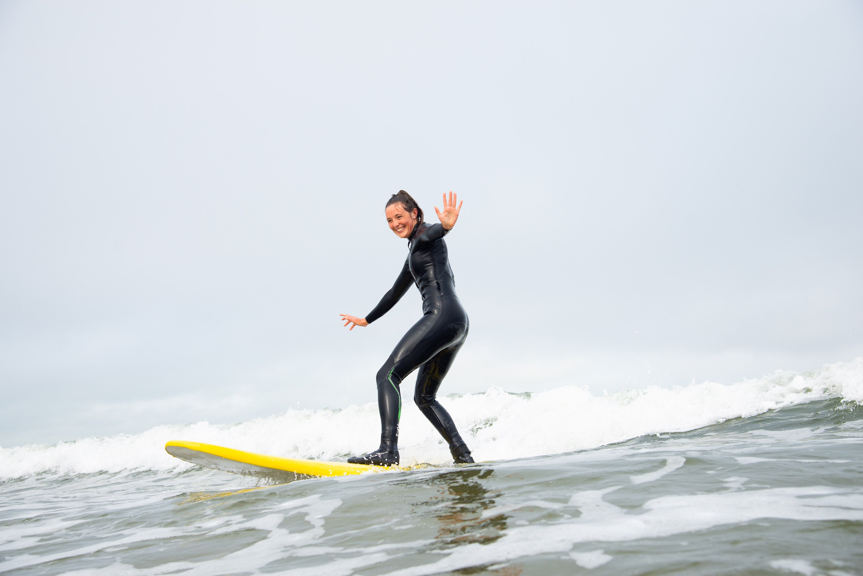 A woman surfing on Strandhill Beach in Co Sligo