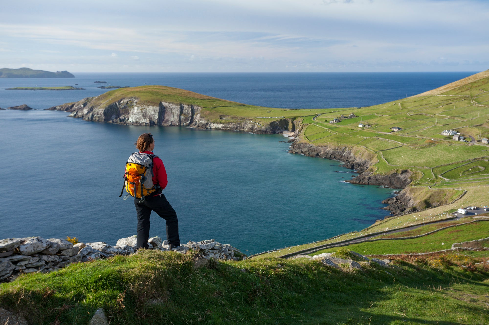 A hiker looking out over Slea Head in Dingle, County Kerry