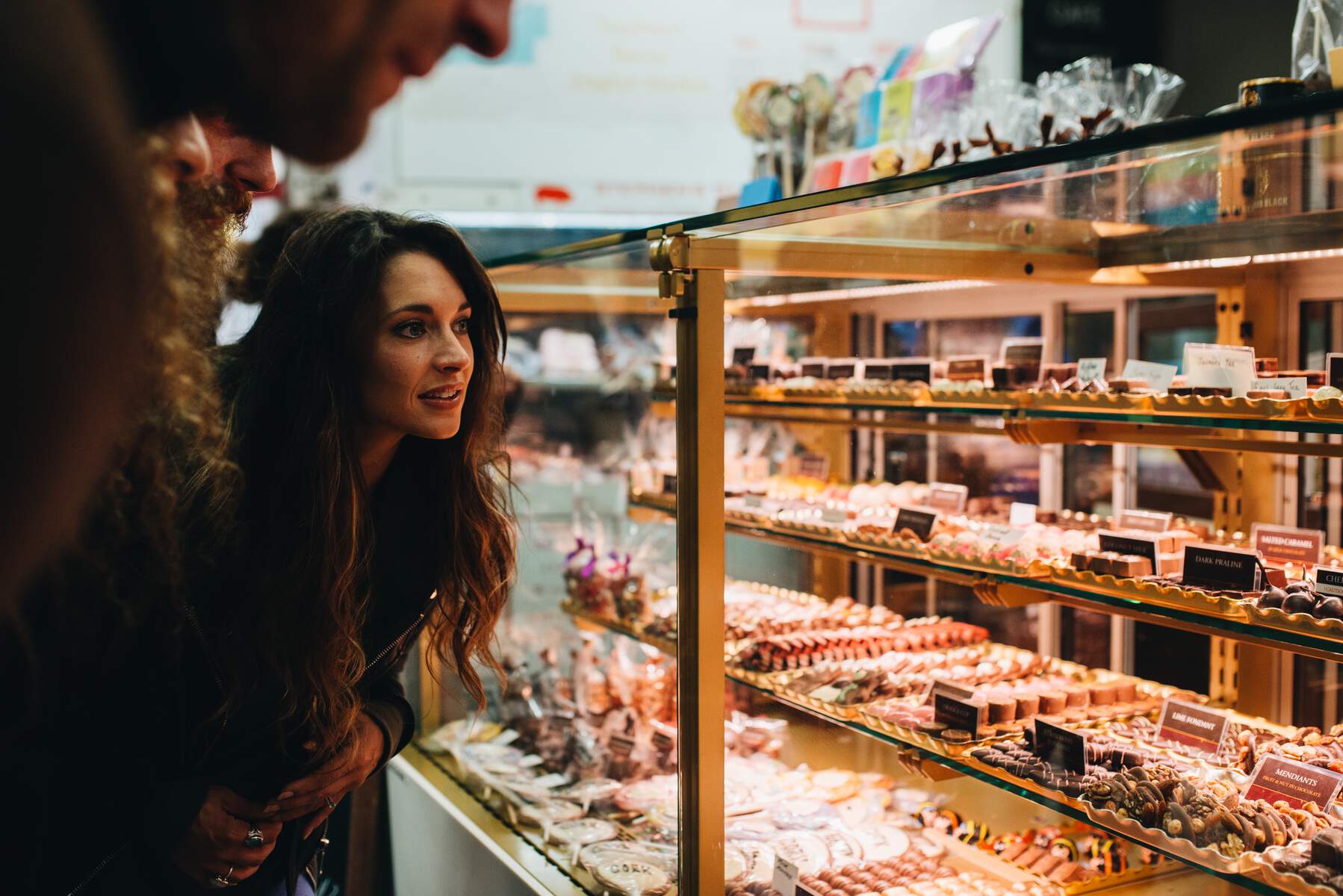 Woman looking at display of baked goods